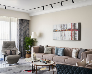 Family living room decorated with pastel colored furniture and unique artwork.